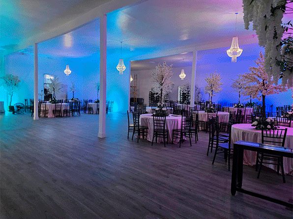 Our new event venue with decorated tables, chandeliers and colorful lighting